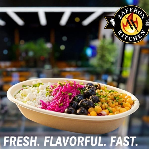 A colorful bowl from Zaffron Kitchen with feta, pickled cabbage, olives, and chickpeas.