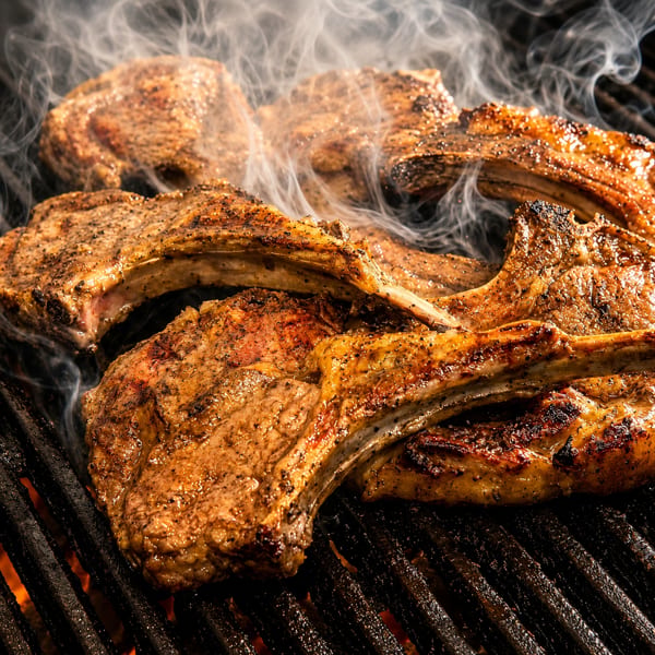 Grilled lamb chops served with fresh herbs and spices, halal-certified.